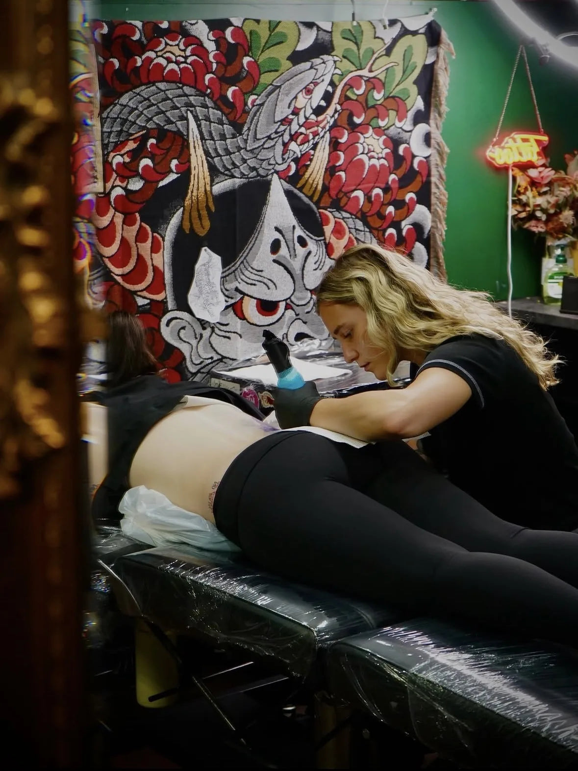 Tattoo artist at work in a studio